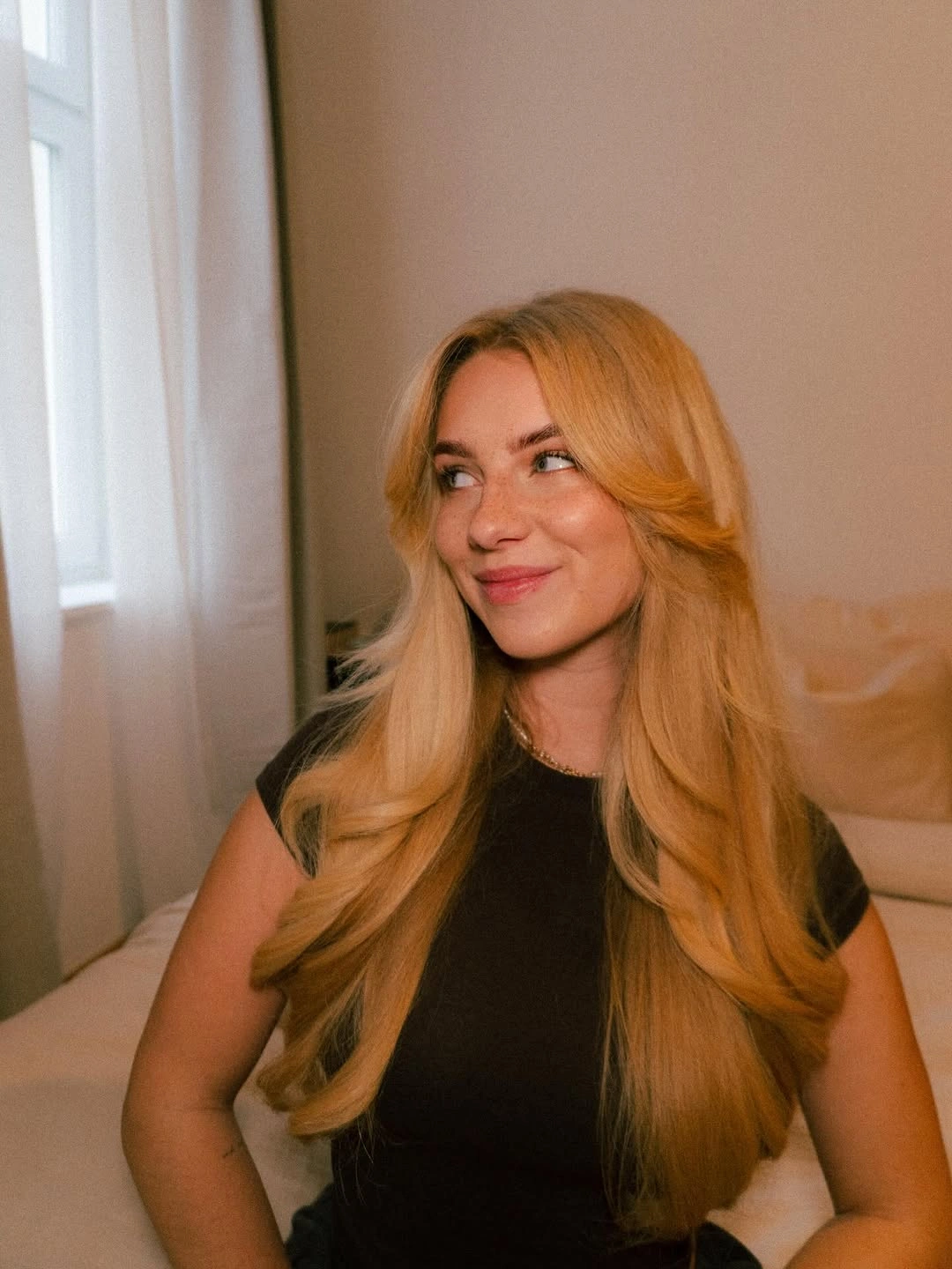 Long golden blonde hair with curtain-style face layers
