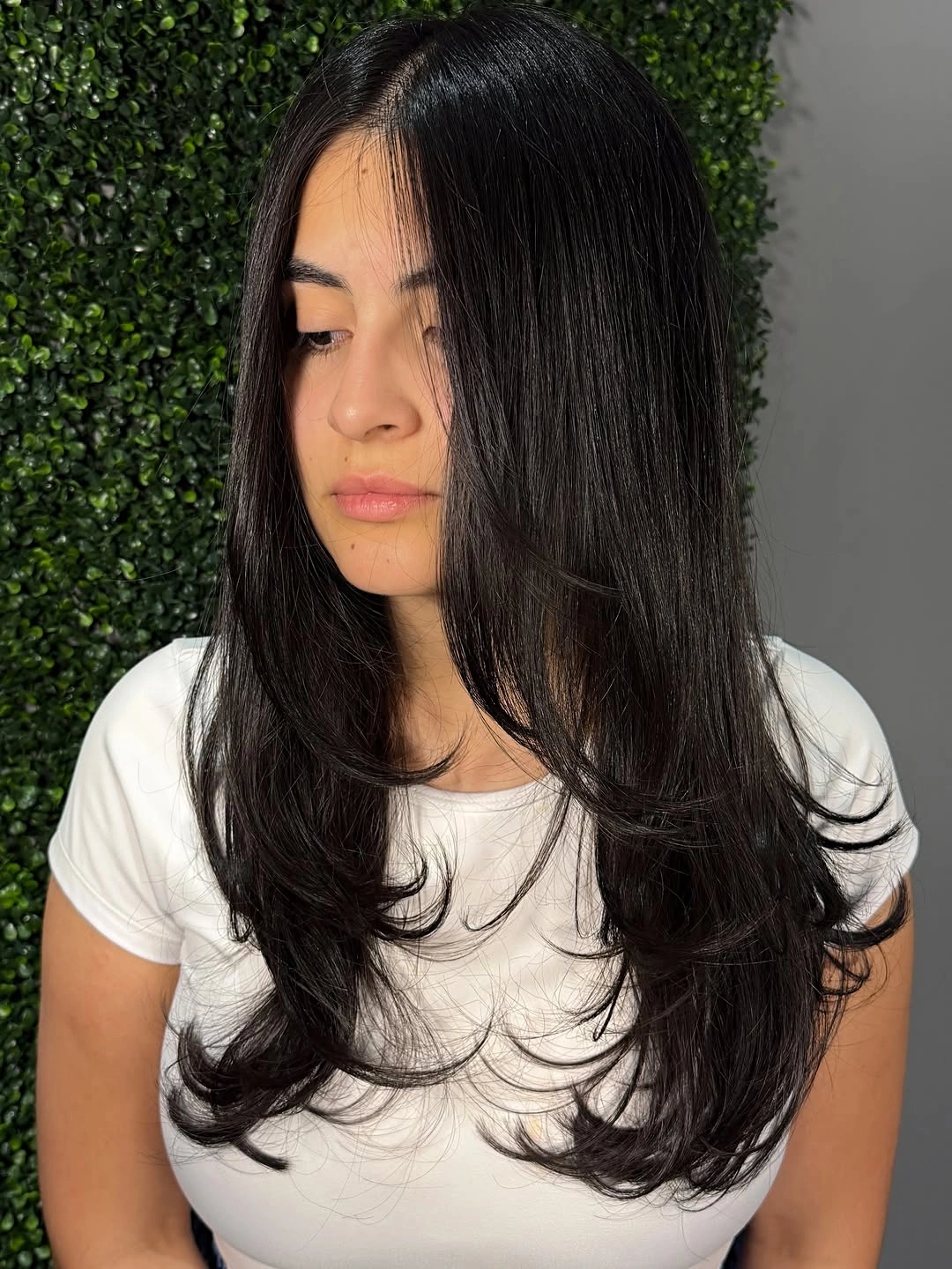 Long black straight hair with face-framing curved layers