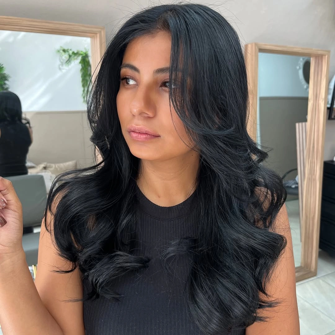 Long glossy dark hair with curled curtain layers