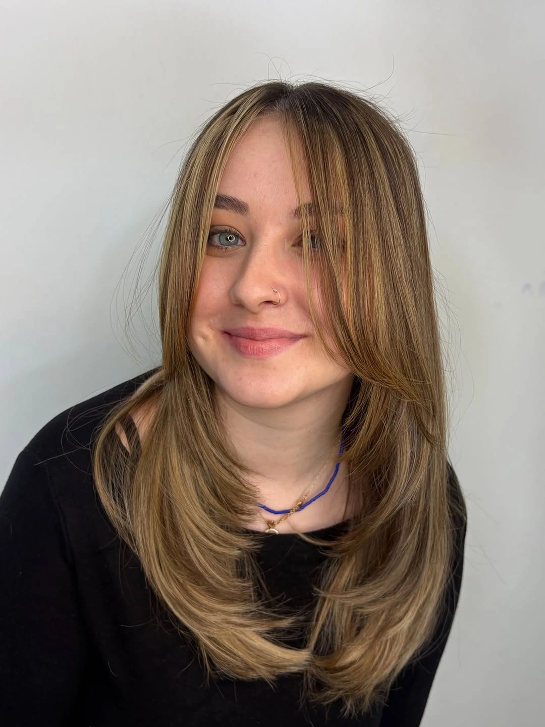 Medium blonde hair with curtain face-framing layers