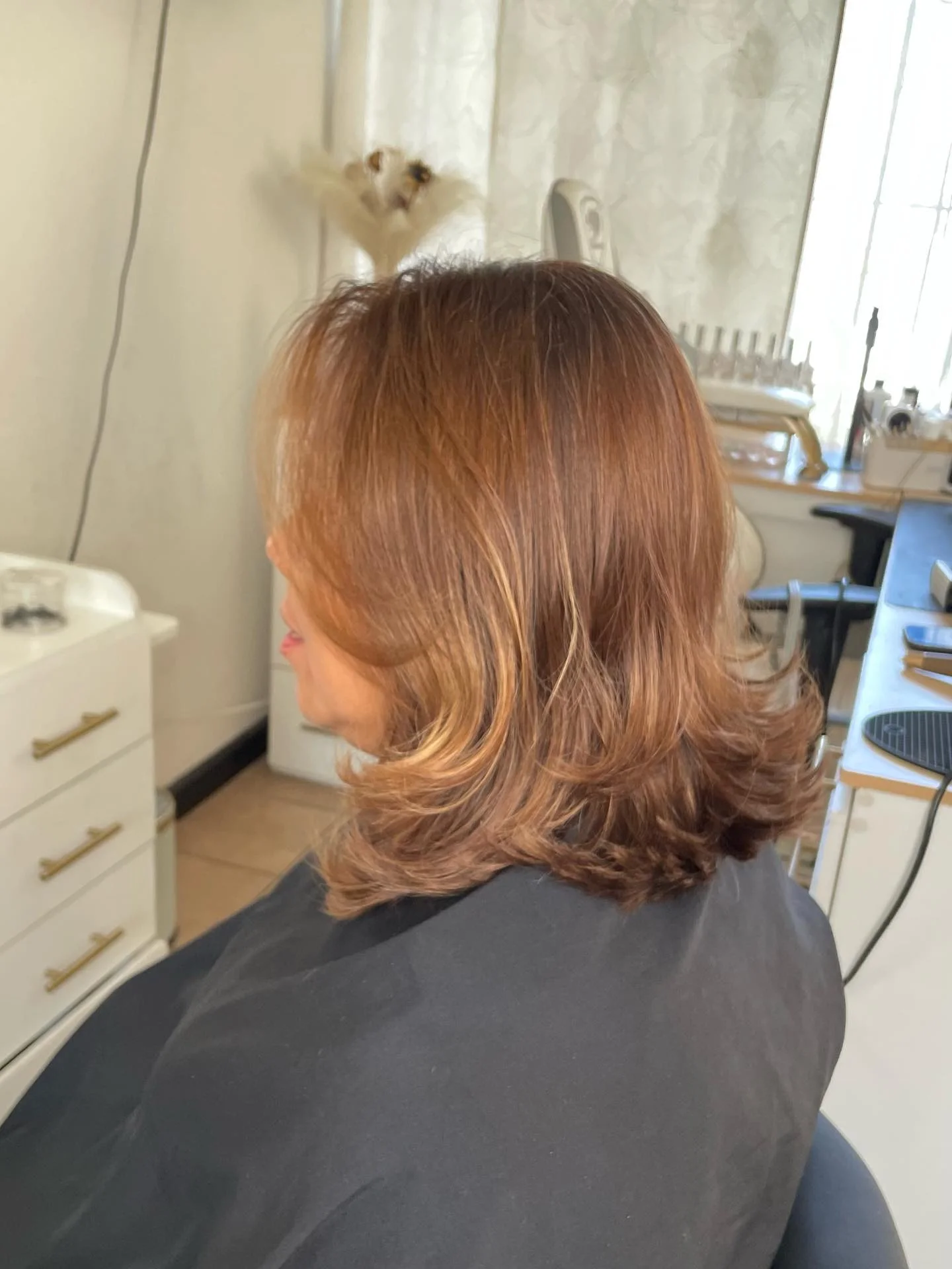 Copper brown medium haircut with feathered flipped ends