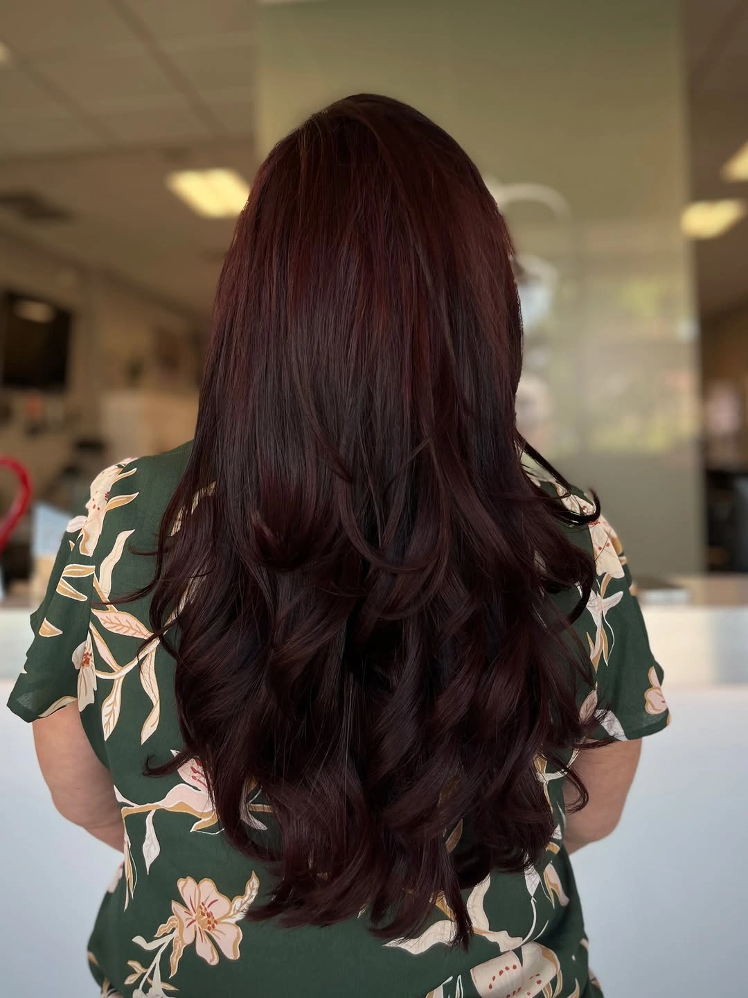 Long burgundy hair with loose curled layered ends