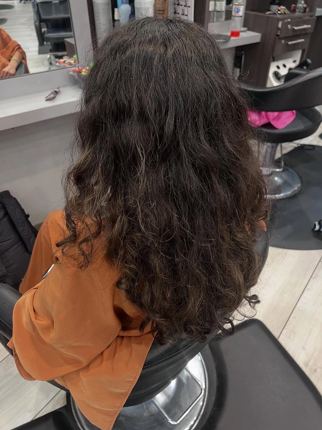 Long dark curly hair with rounded layered-looking outline