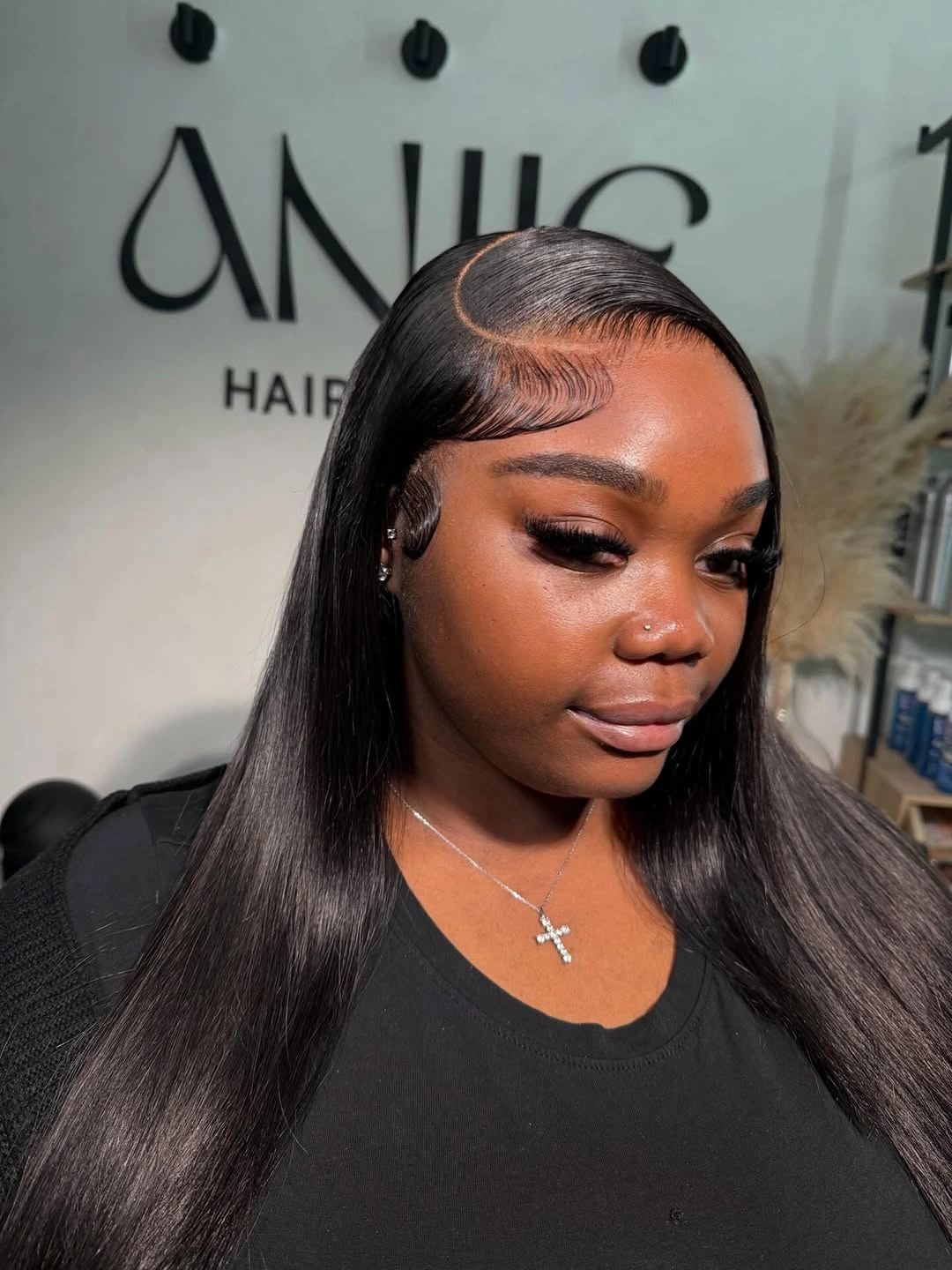 Long straight black hair with curved side part and styled edges