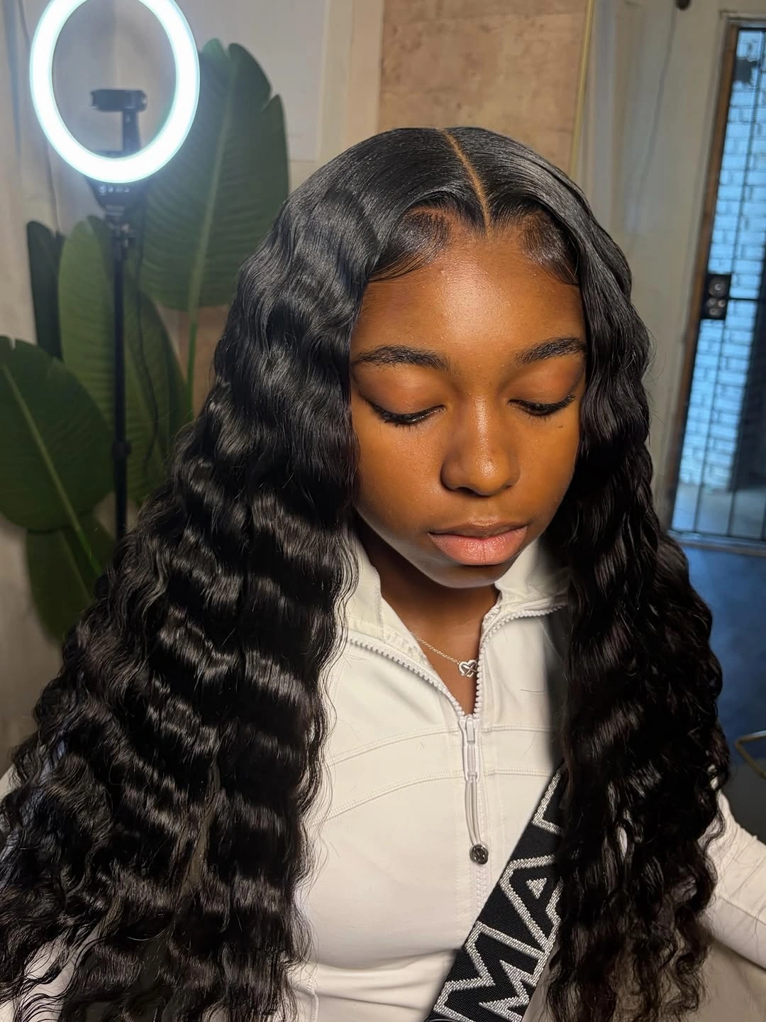 Long black hair with center part and rippled waves