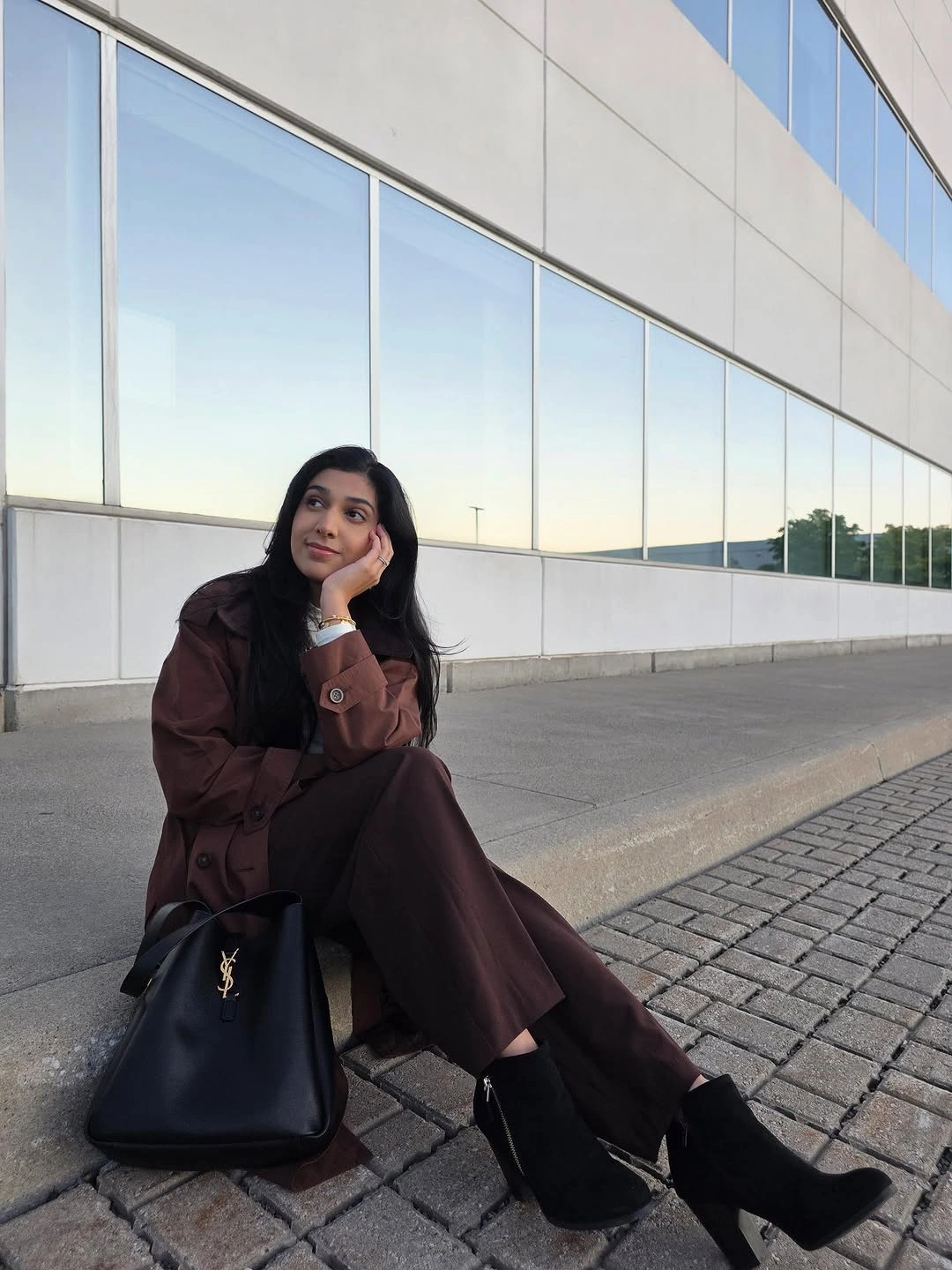 Dark brown jacket and wide trousers with black top and accessories