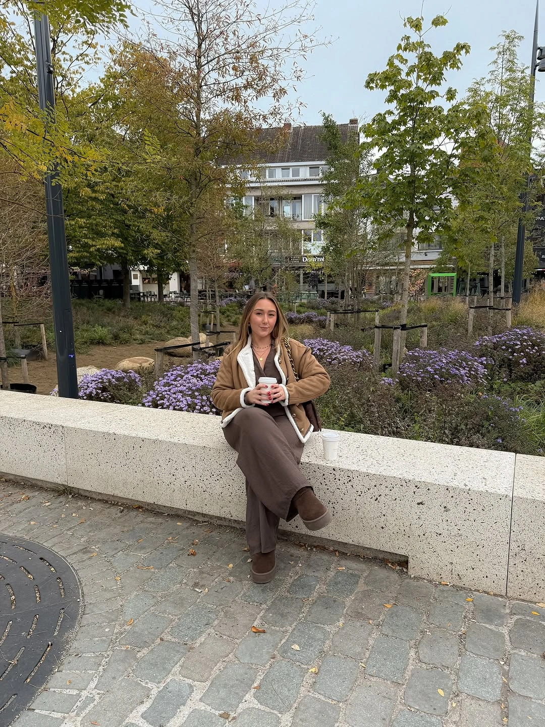 Tan-brown jacket, pale inner layer, loose brown trousers, brown shoes