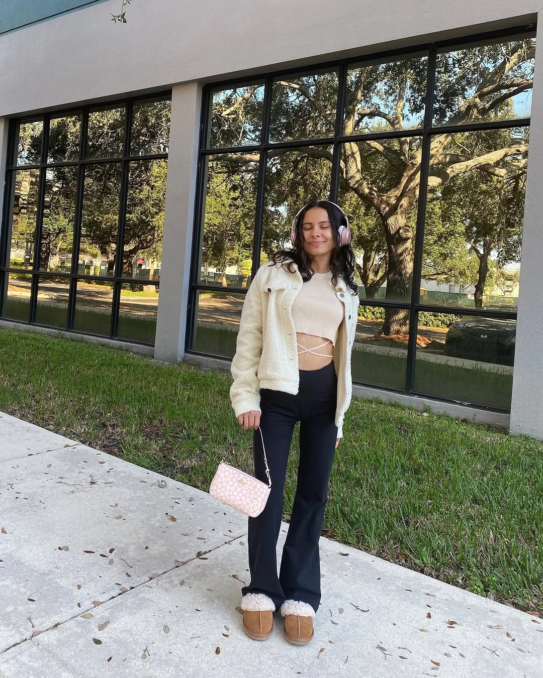 Off-white cropped jacket, white tie-detail top, black flared trousers, pale accessories