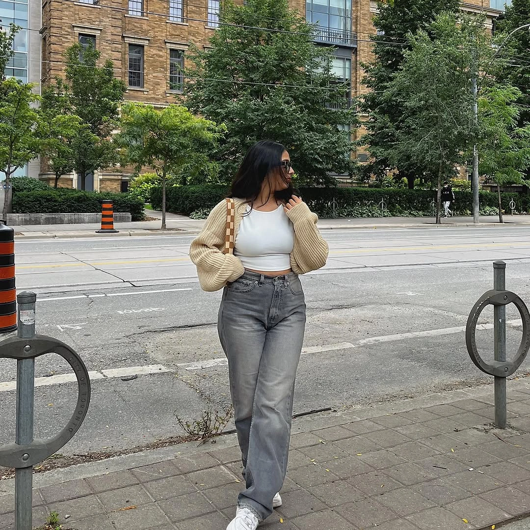 Cream cropped layer, white tank, gray jeans, sneakers, checked bag