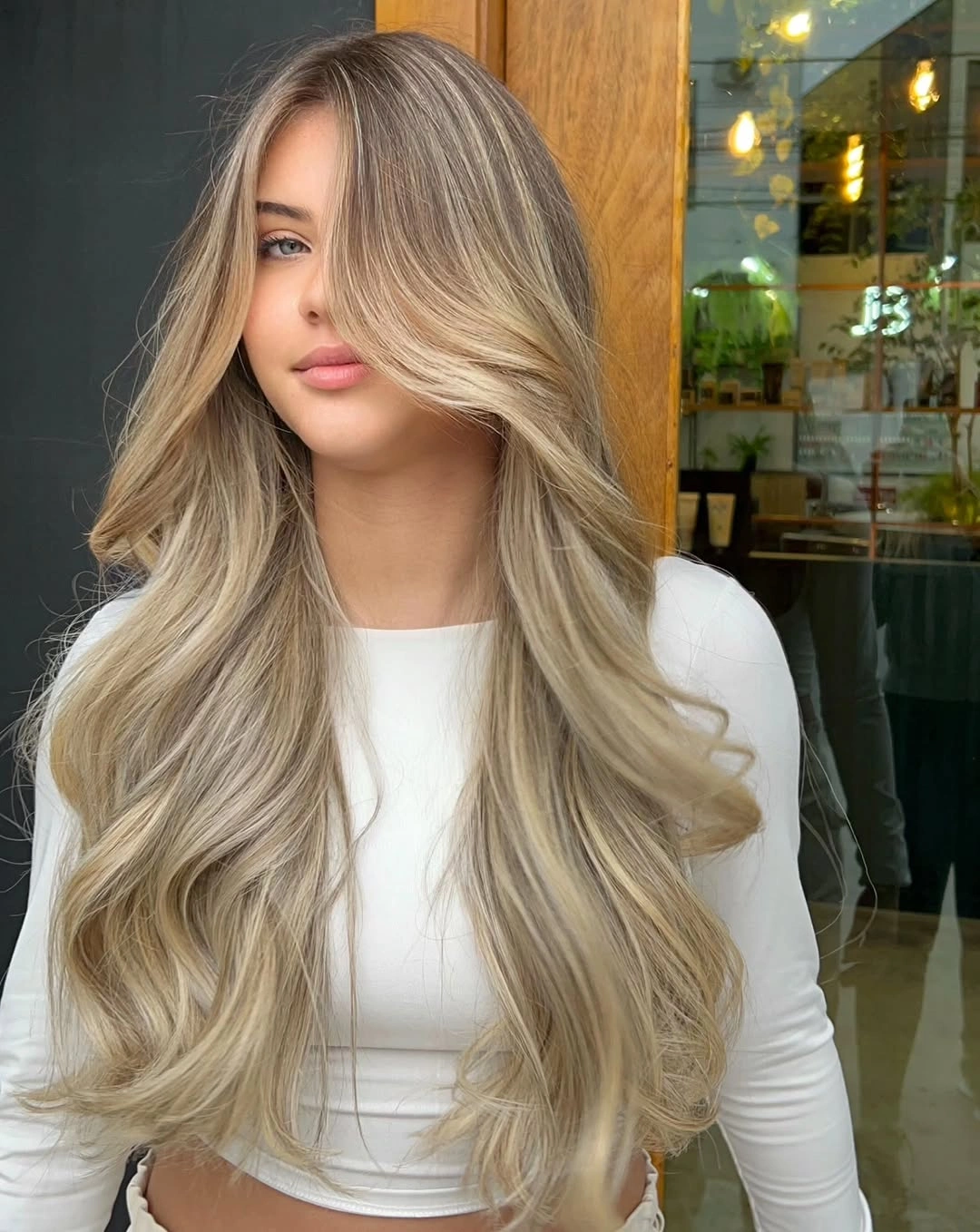 Long beige ash blonde hair with sweeping front layers