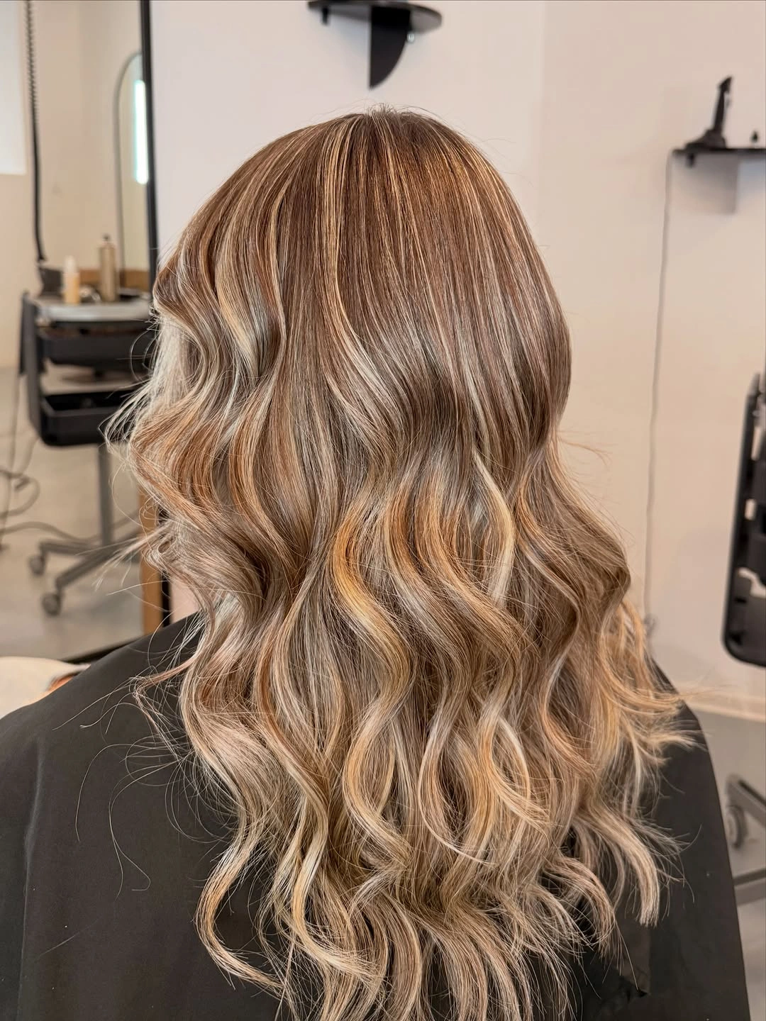 Long champagne beige blonde waves viewed from behind