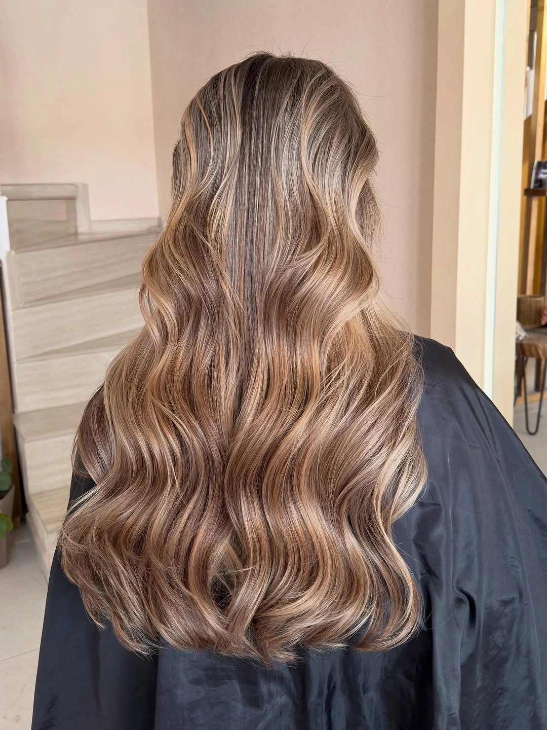 Long beige caramel blonde waves viewed from the back