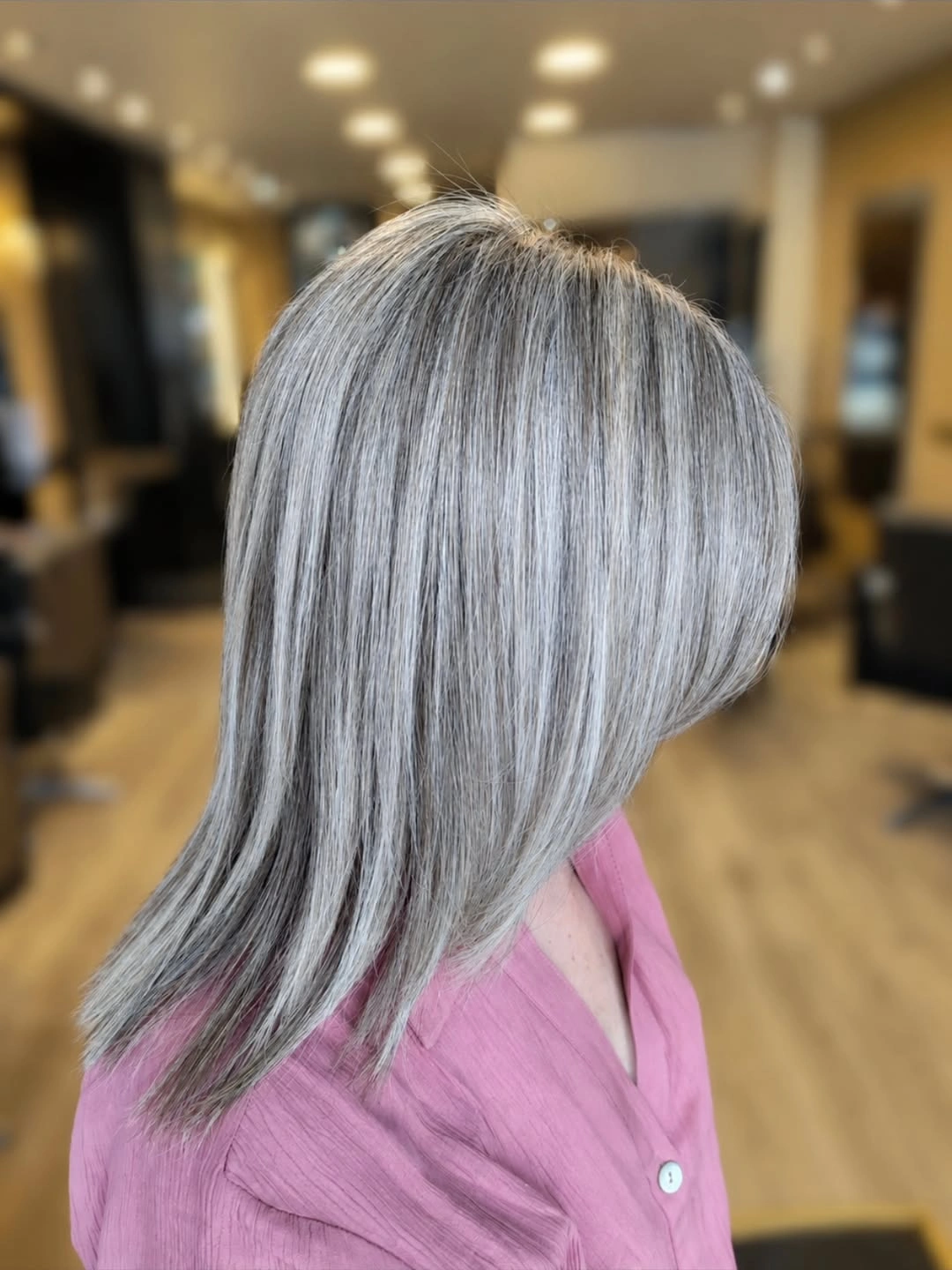 Short medium silver grey layered hair seen from the side