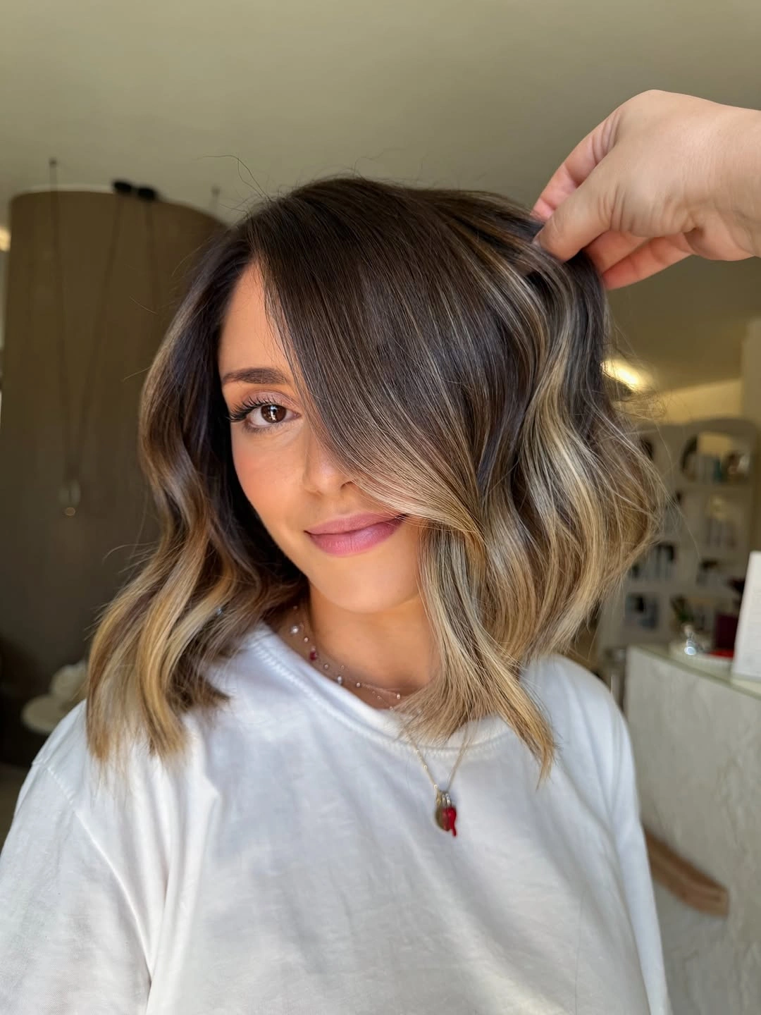 Shoulder-length dark brown waves with lighter front pieces