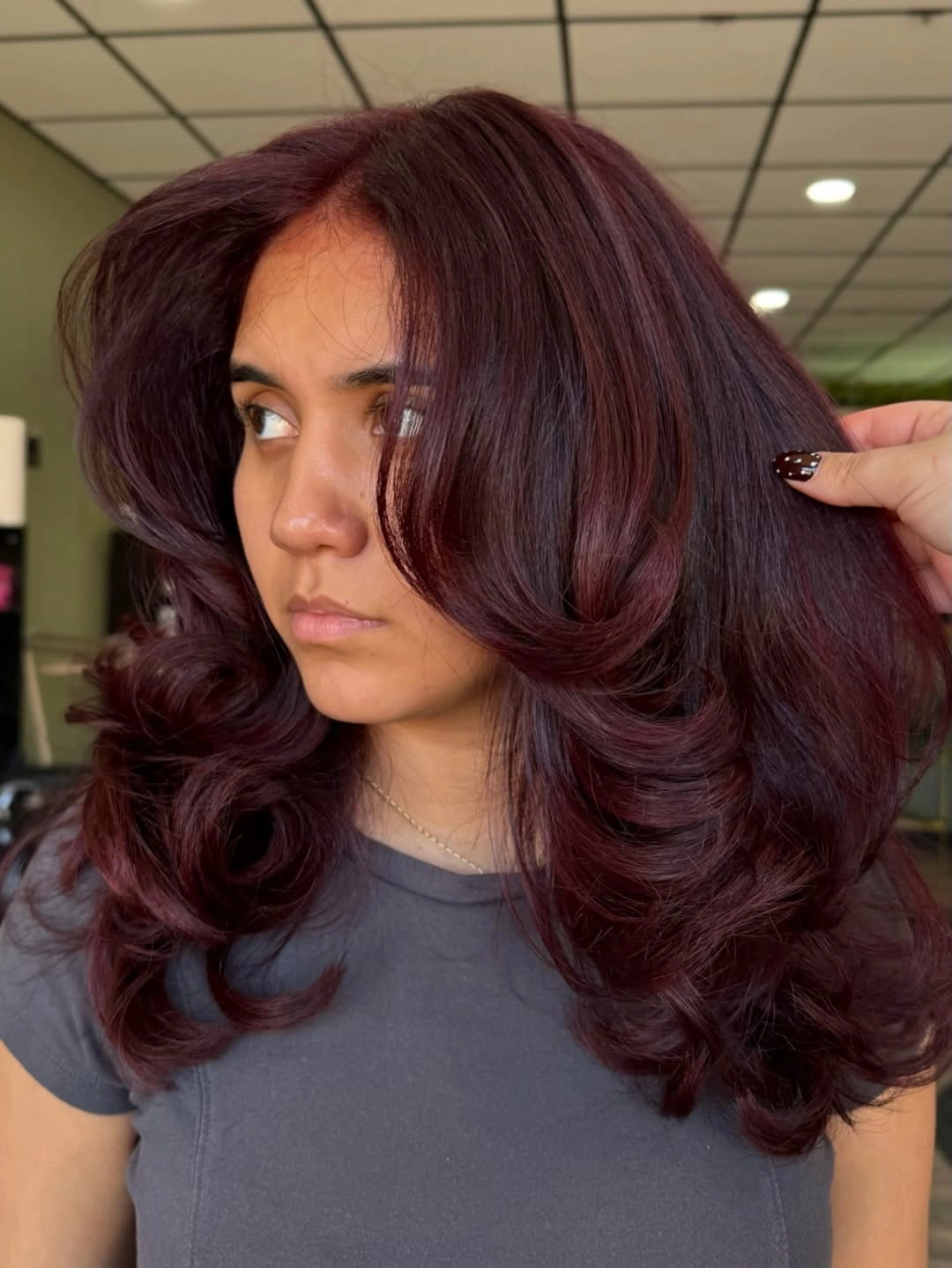 Long burgundy wine hair with rounded waves and side volume