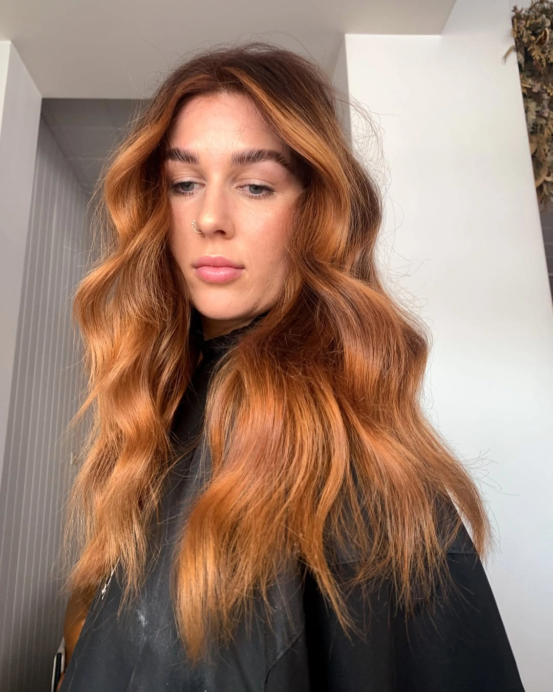 Long copper red waves with center part and face-framing layers