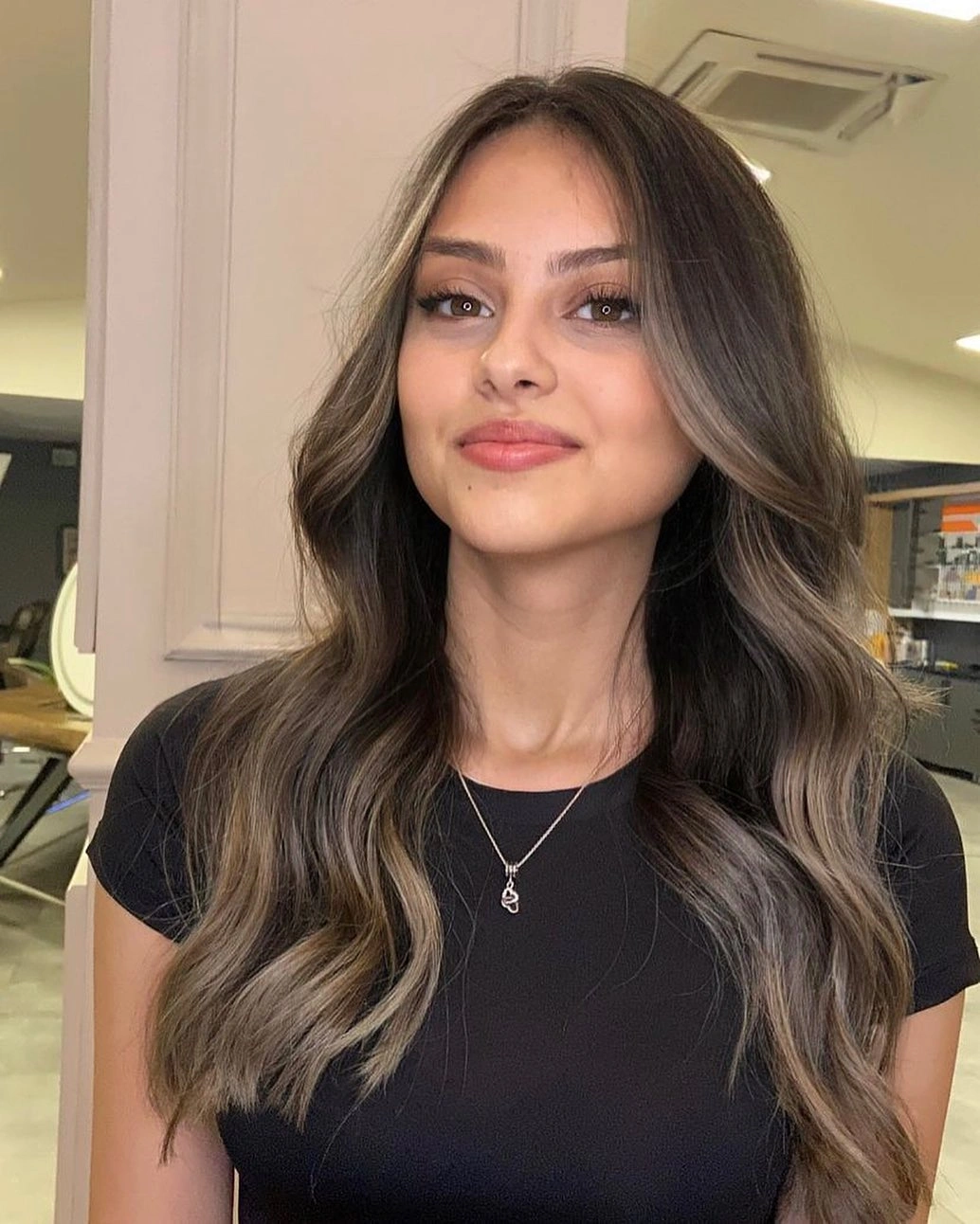 Long dark brown waves with lighter front pieces and center part
