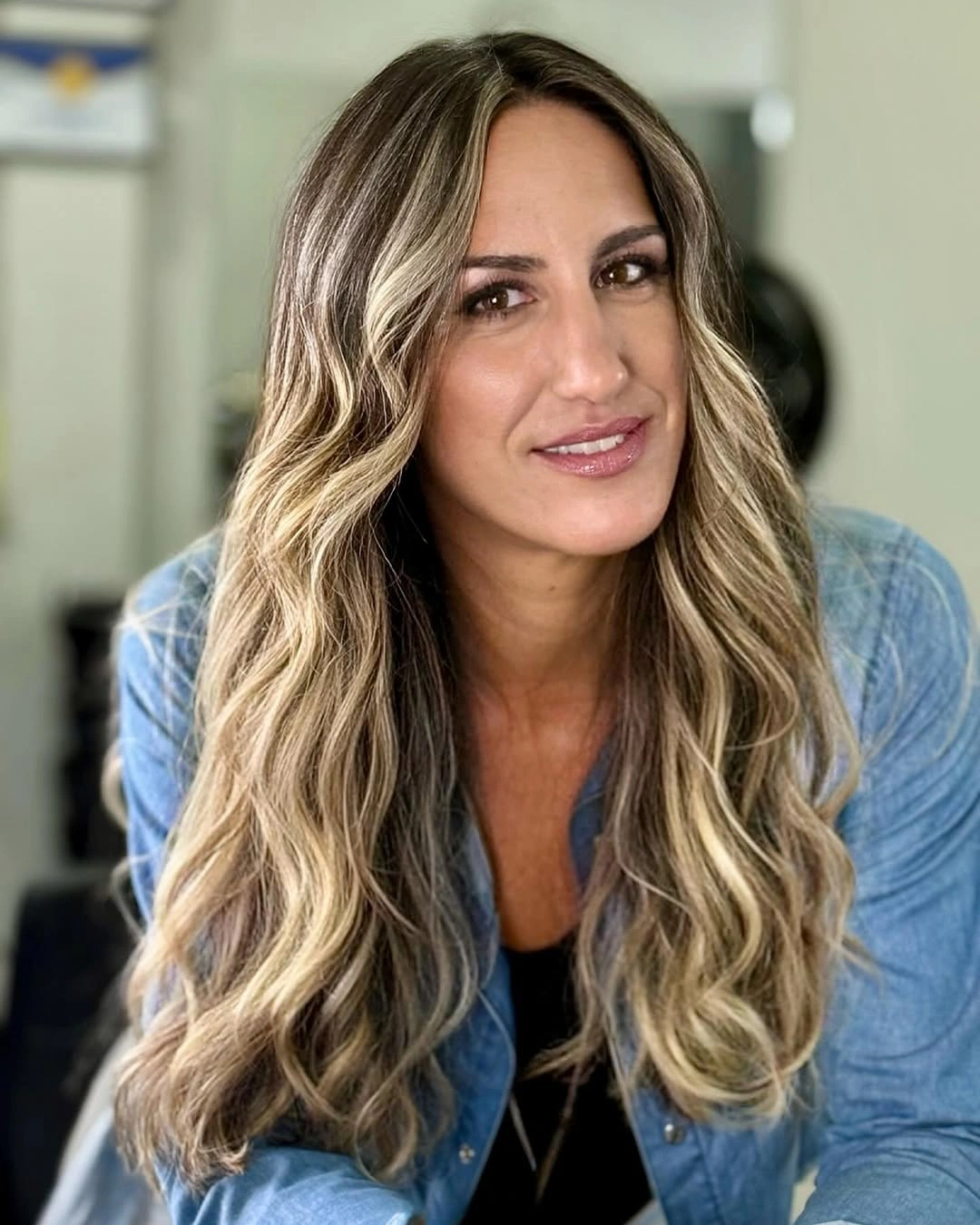 Long highlighted blonde waves with darker roots and layered front pieces
