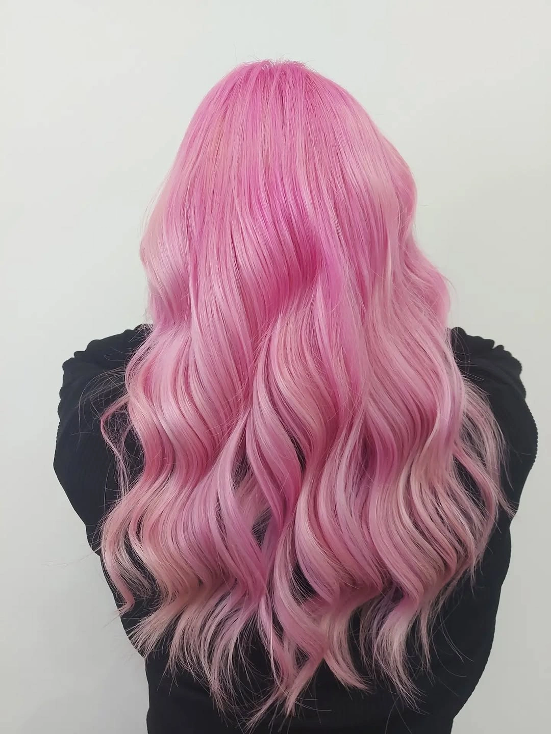 Long pink wavy hair viewed from the back