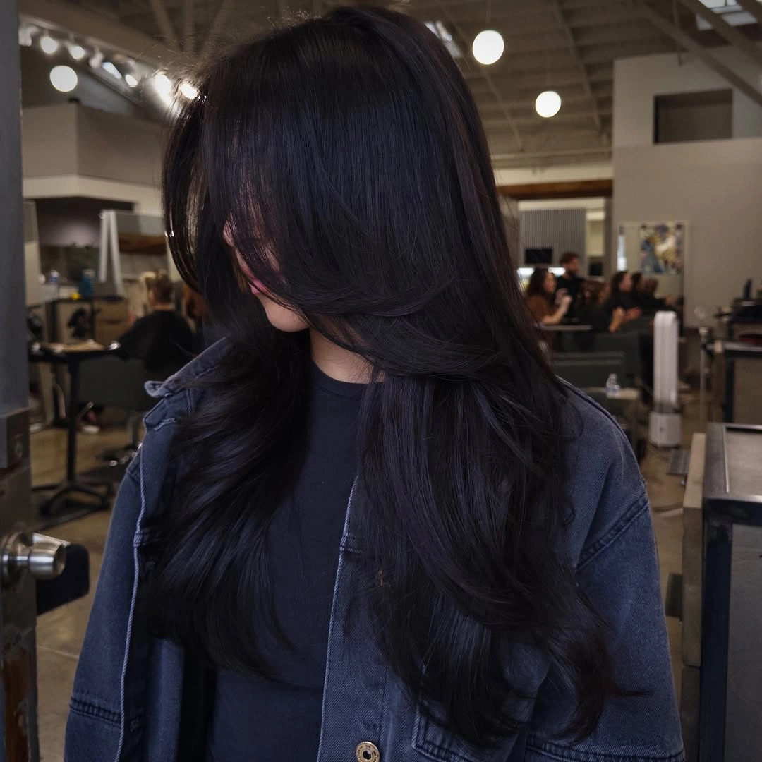 Long deep black hair with sweeping face-framing layers