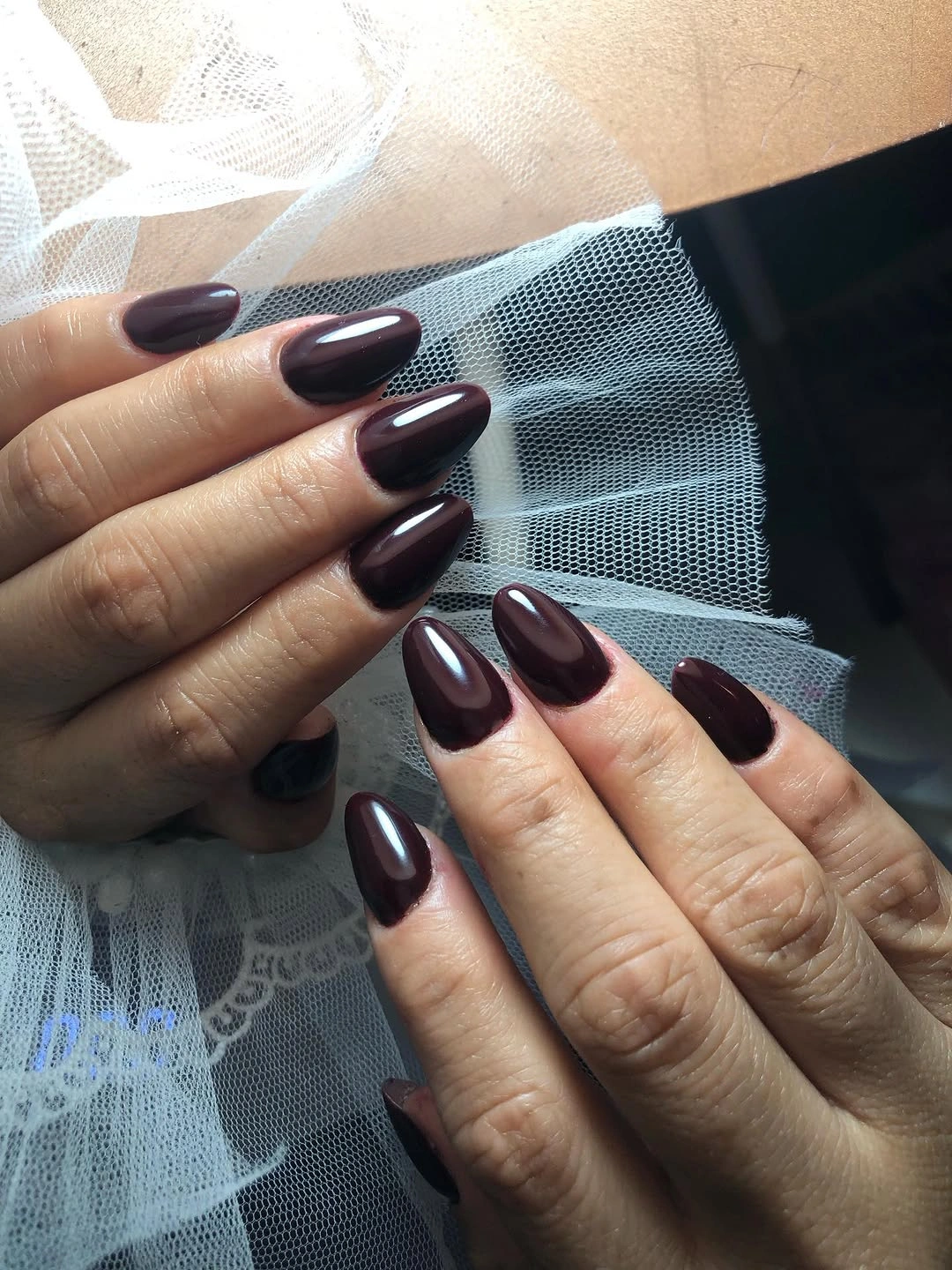 Long almond wine nails with glossy dark finish on both hands