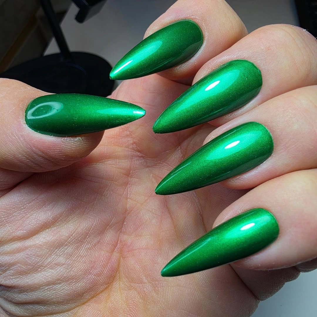 Pointed emerald green nails with metallic-looking reflective center shine