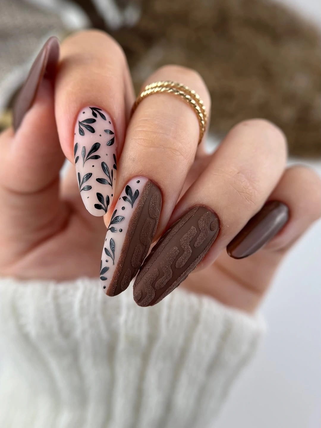 Long almond nails with brown texture and black leaf marks