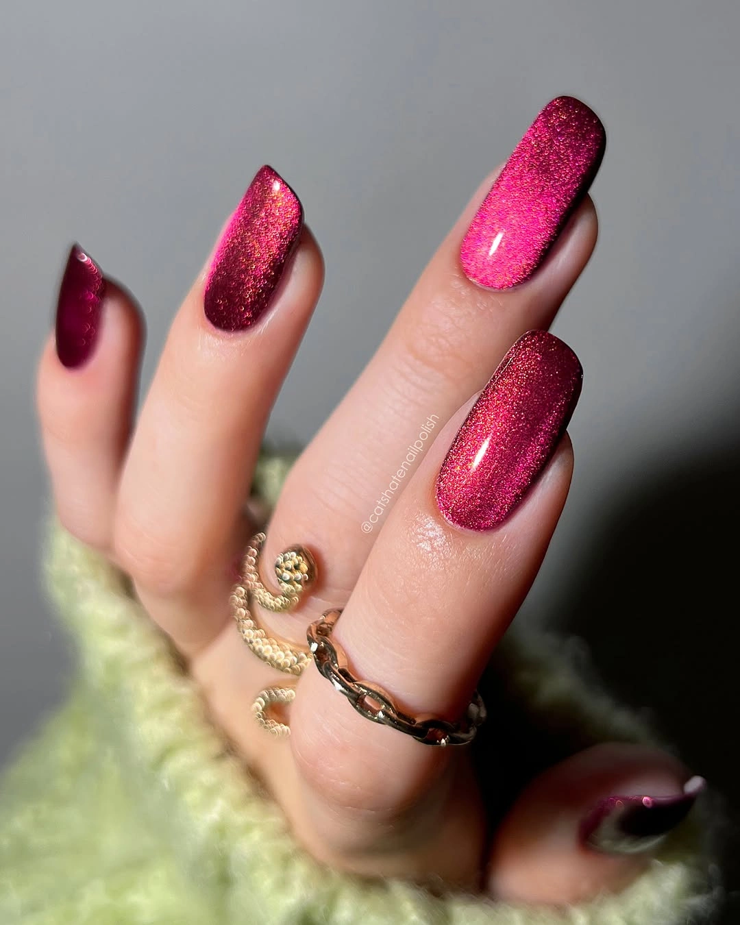 Long berry-magenta almond nails with reflective cat-eye-like glow