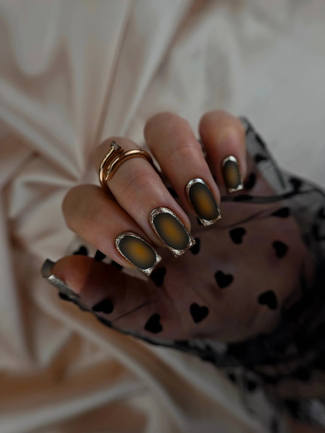 Short smoky nails with amber centers and glittered outlines