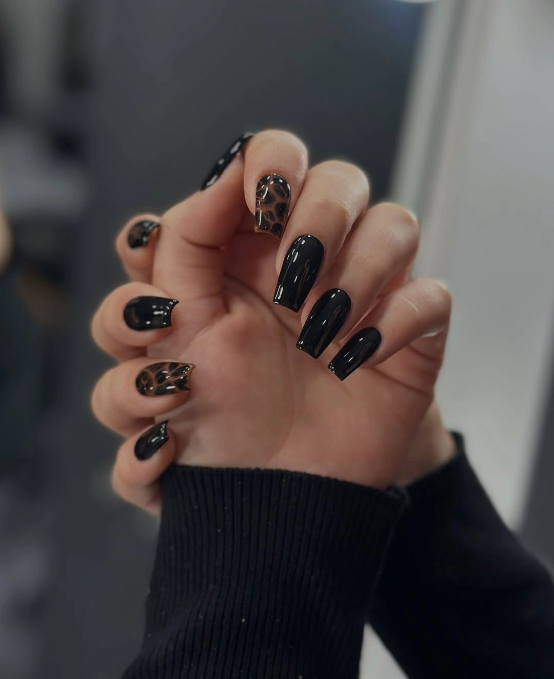Medium squared black nails with brown leopard-like accent details
