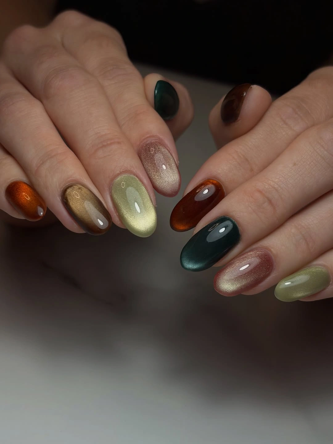 Oval nails with green amber brown teal and champagne shimmer
