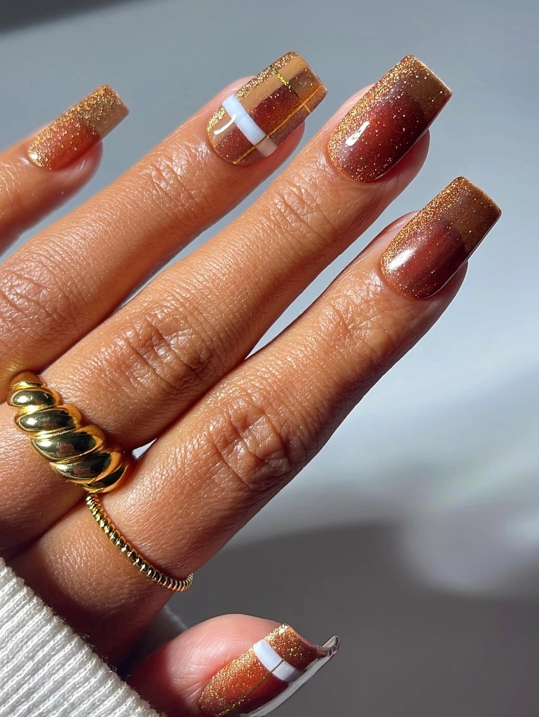 Long square nails with amber burgundy glitter and white stripe