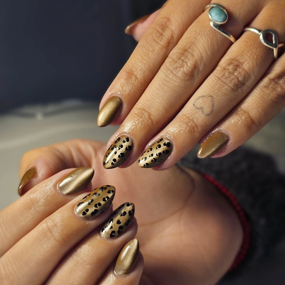 Short oval nails with metallic-looking gold and black-brown leopard-like spots