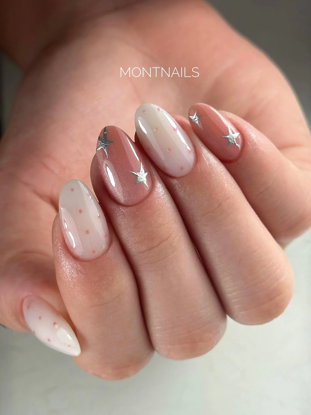 Rosy and off-white almond nails with silver stars and pink dots