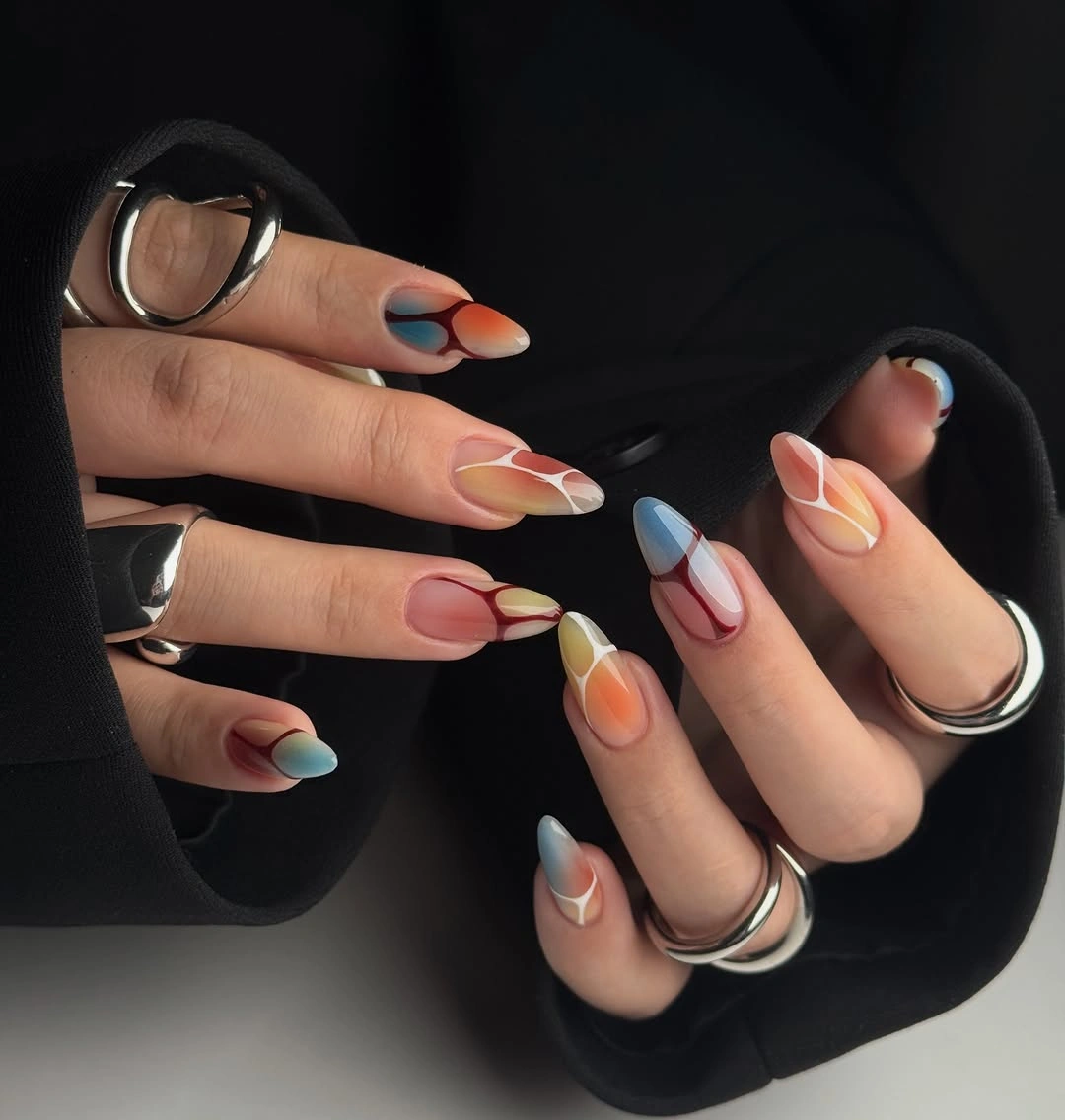 Long almond nails with abstract multicolor shapes and curved white lines