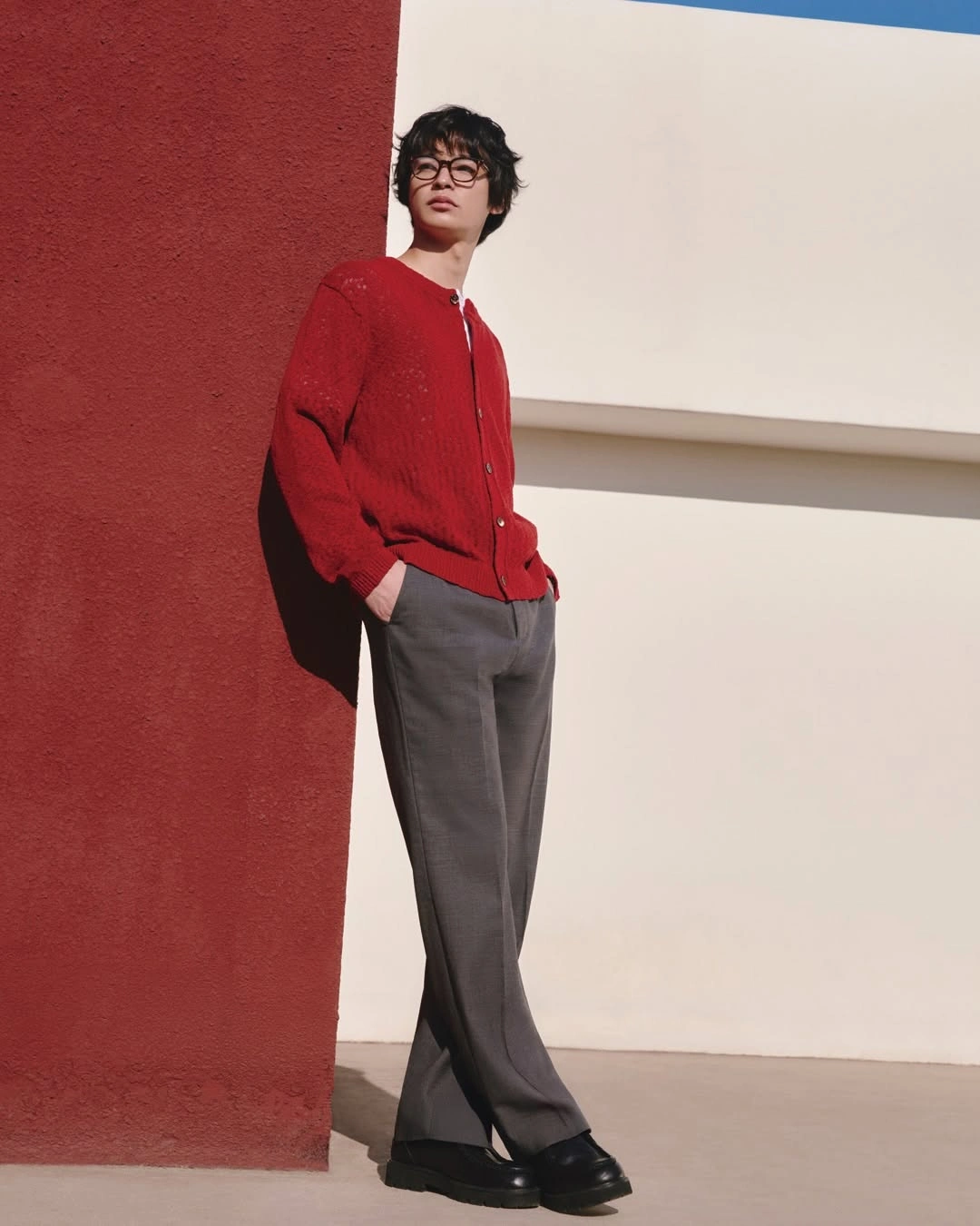 Blue striped overshirt white T-shirt black trousers and navy cap