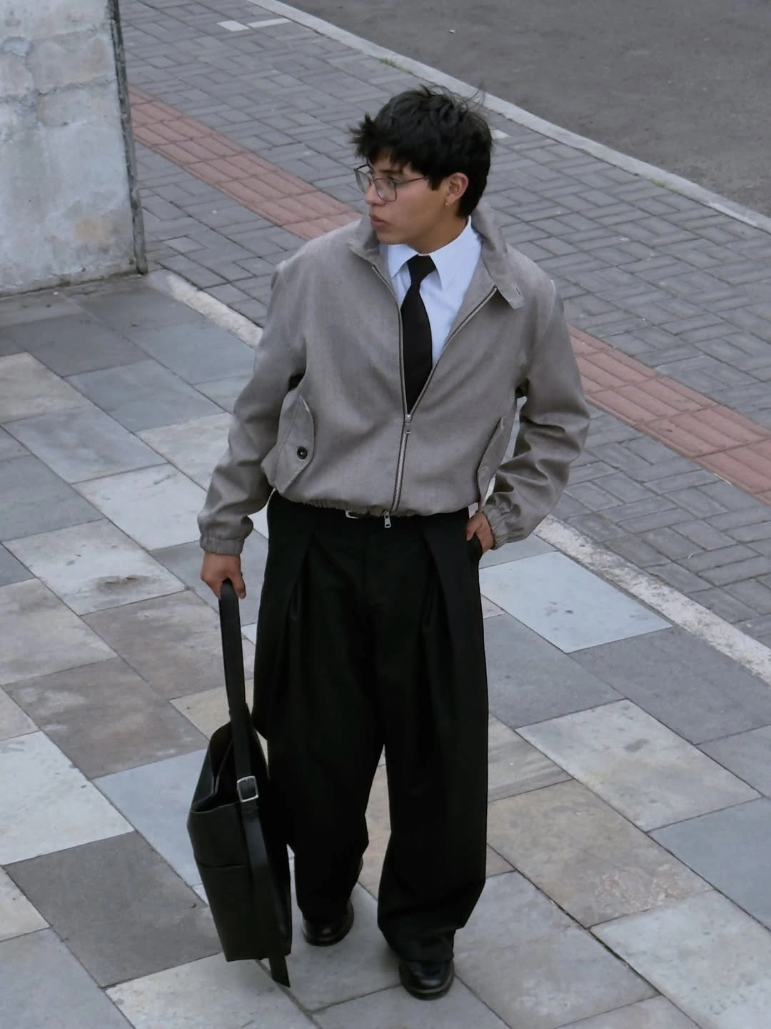 Black abstract print shirt with cream trousers dark loafers and sunglasses