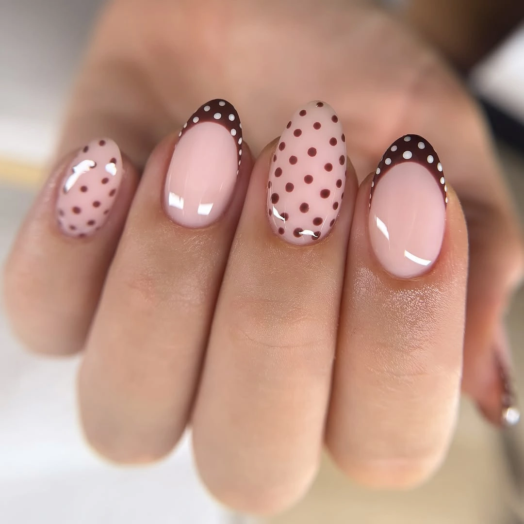 Short nude rounded nails with brown dotted French tips