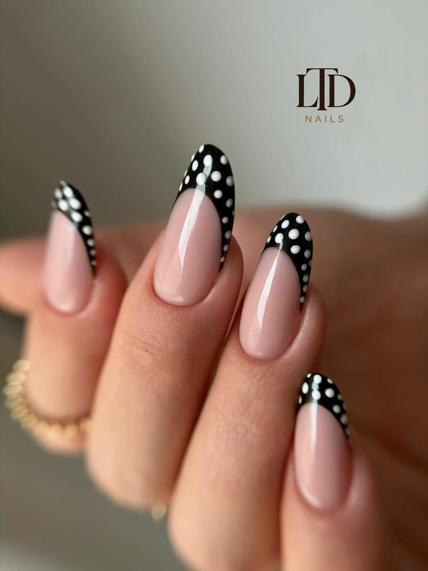 Long nude tapered nails with pointed white black dotted French tips
