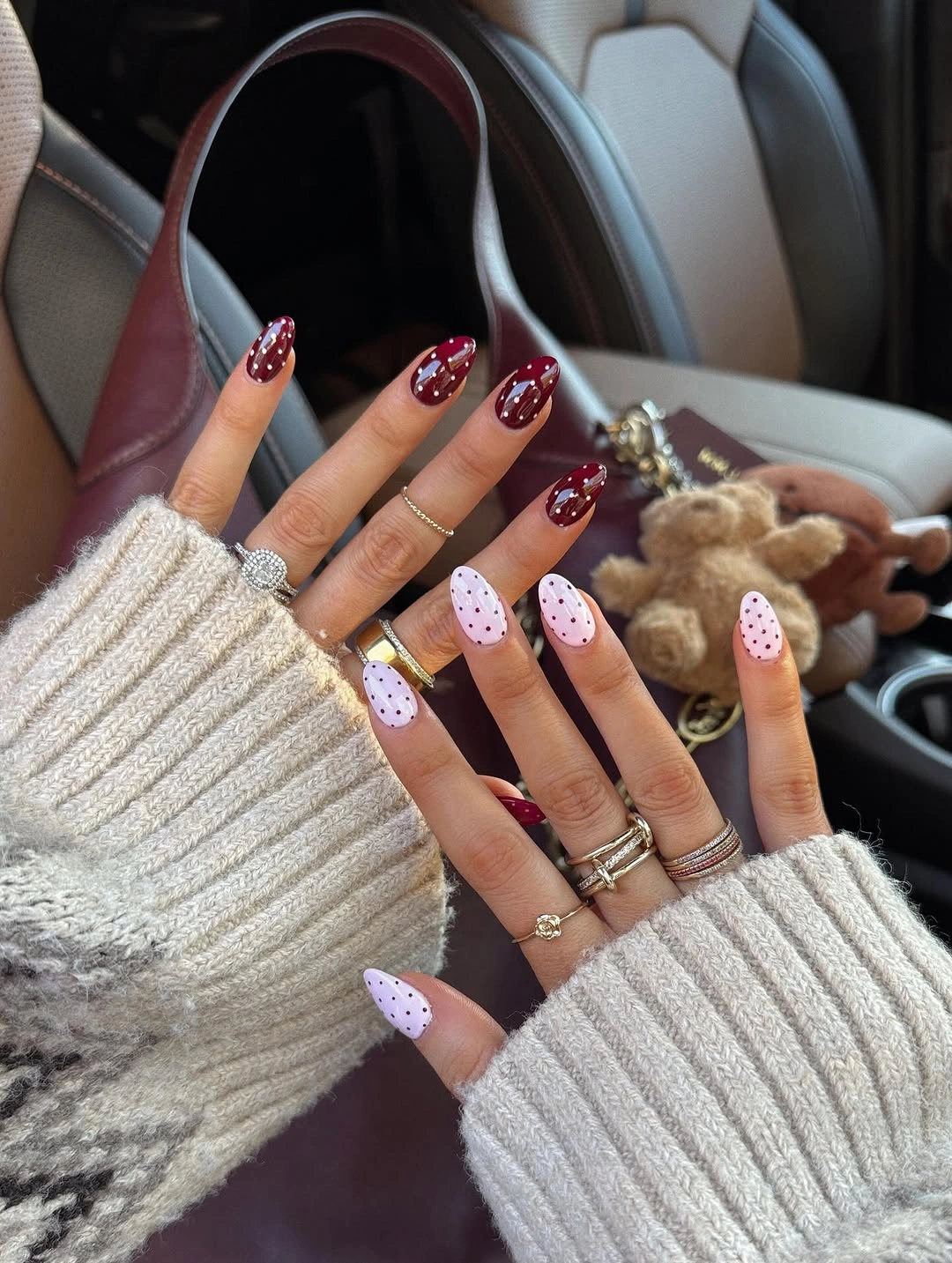 Pale pink pointed nails with red tips dots and clusters