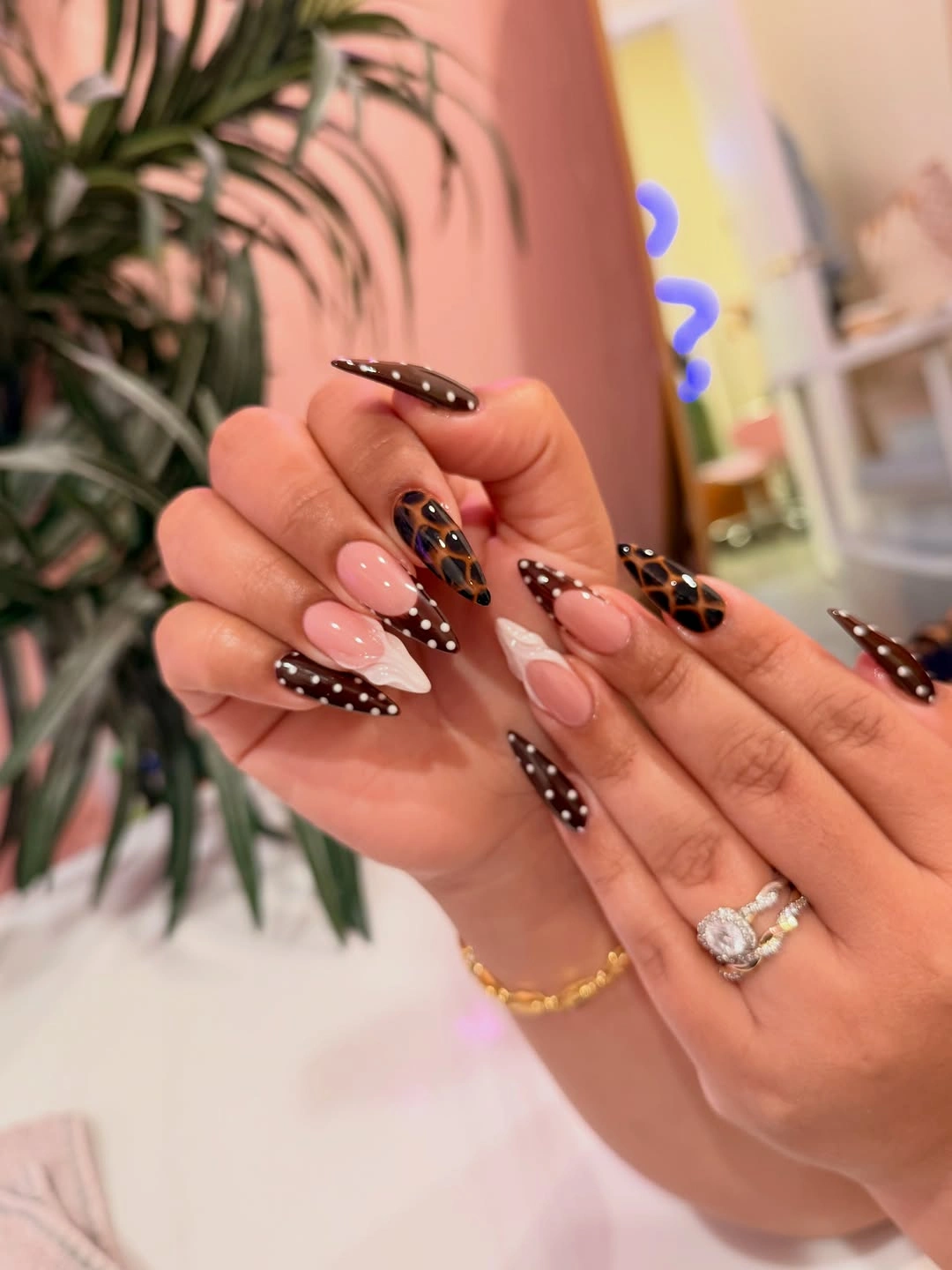 Blush almond nails with brown dotted French tips