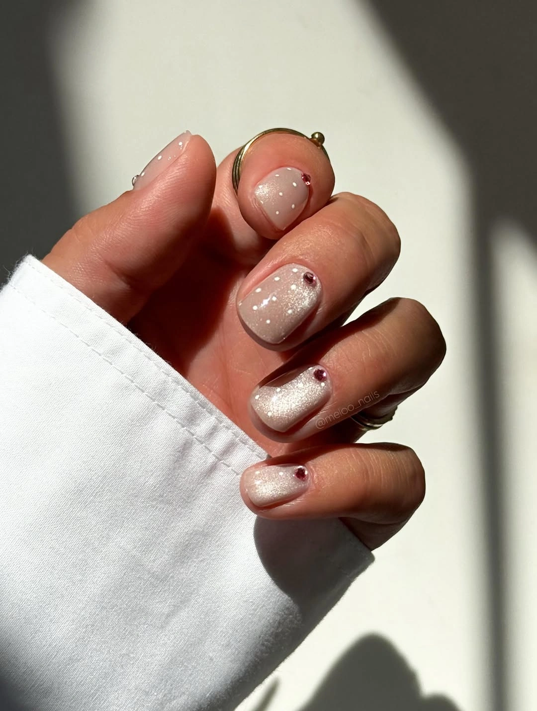 Short nude nails with black dotted white accent and red detail