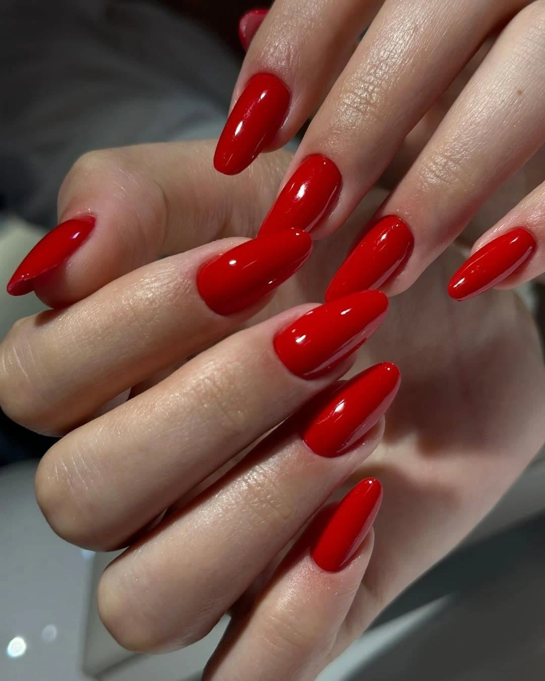 Long almond nails in glossy bright red