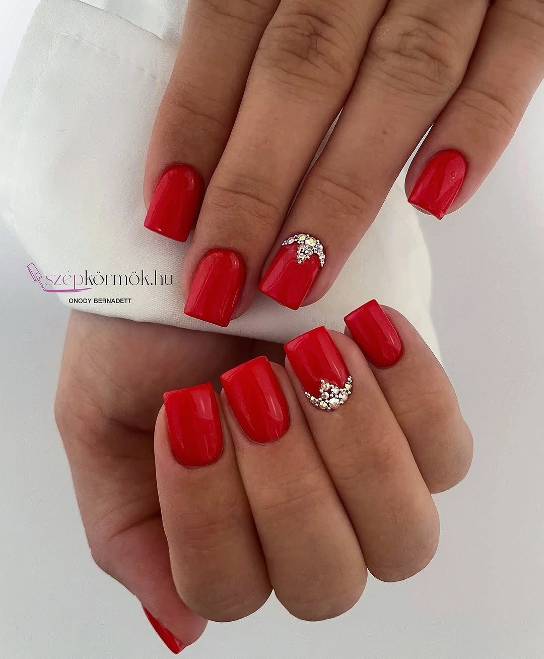 Short square bright red nails with silver accents on two nails