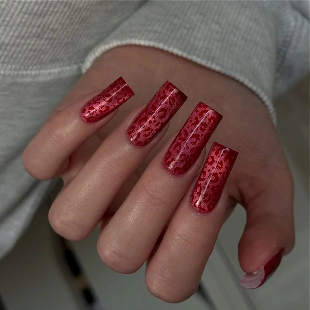 Long square red nails with darker red patterned texture
