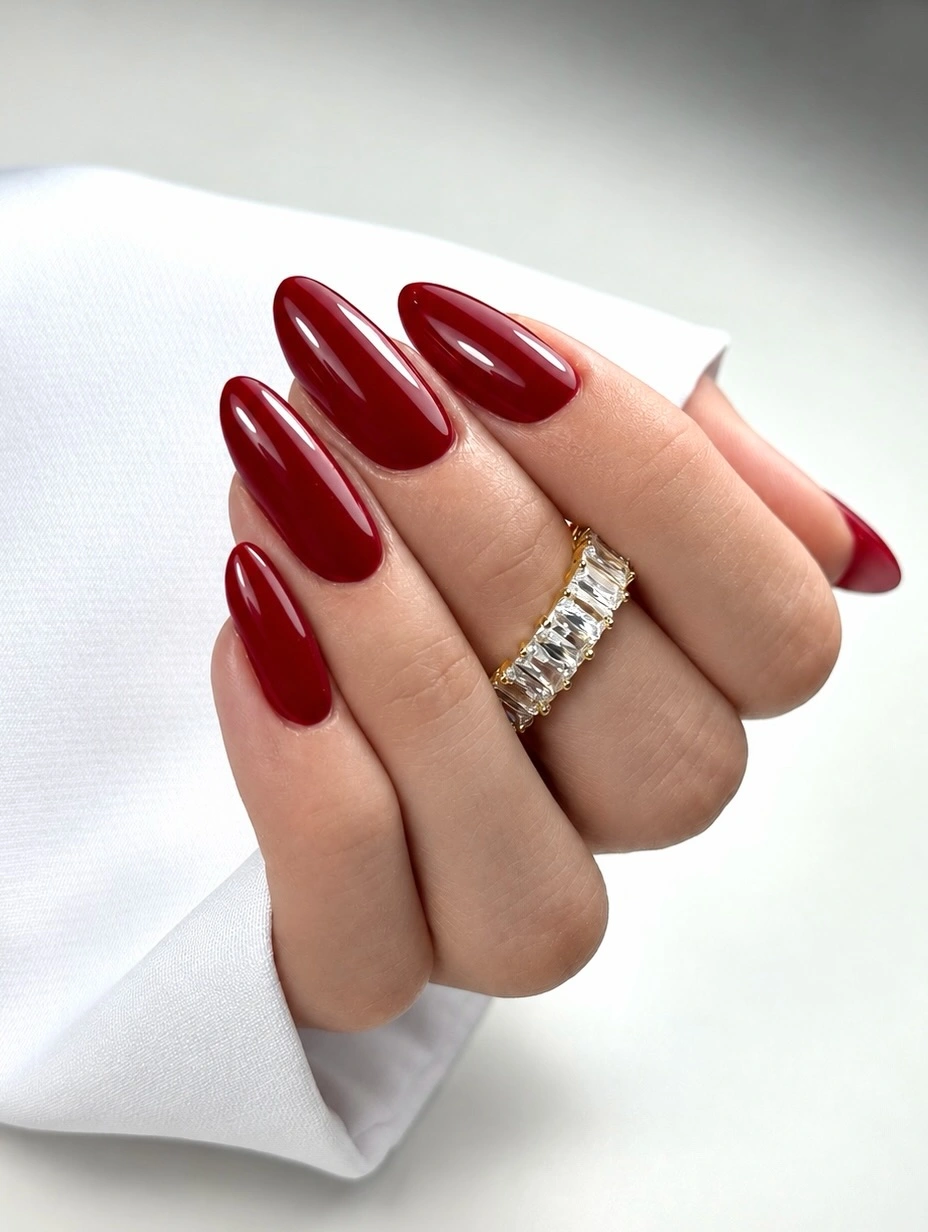 Long almond deep burgundy nails with solid glossy finish