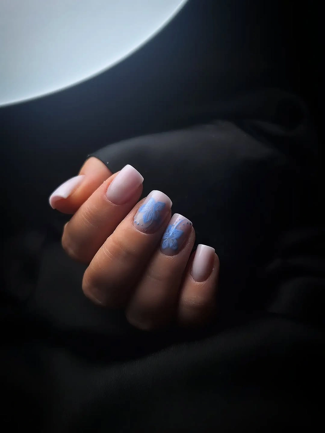 Pale pink short nails with two blue washed accent nails