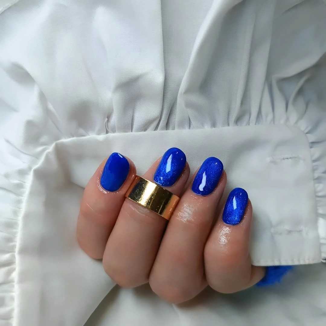 Vivid cobalt glossy short nails with visible shimmer