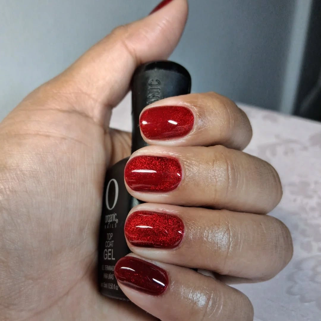 Red glitter short nails with one darker burgundy nail