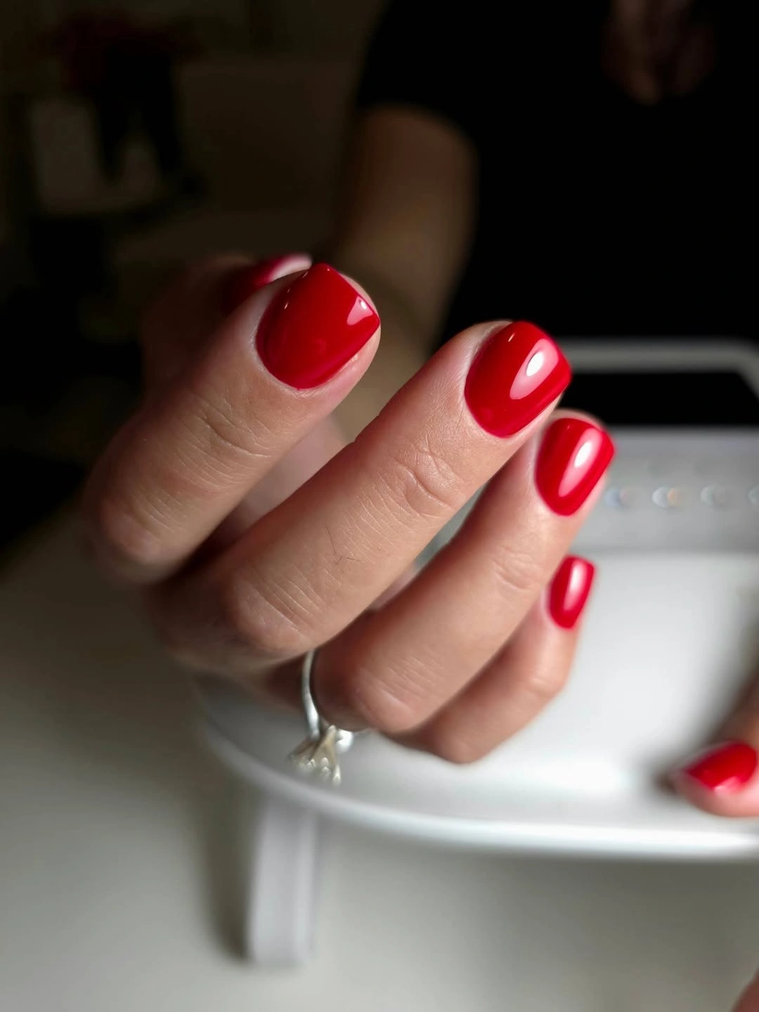 Bright glossy red short nails with rounded edges